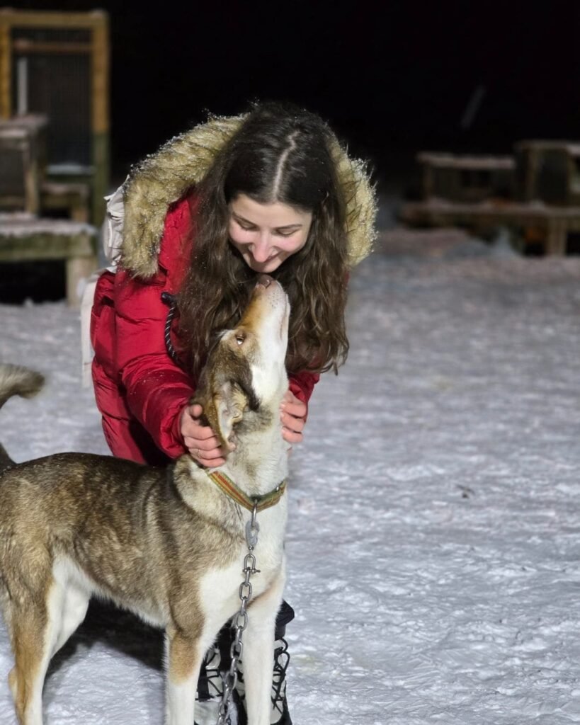 Husky Farm Visit - me playing with the huskies in the snow.