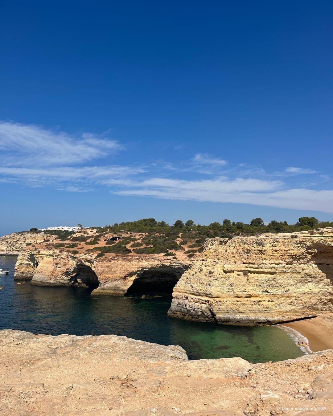 Golden limestone cliffs and turquoise waters along the rugged coastline of the Seven Hanging Valleys hike in the Algarve.