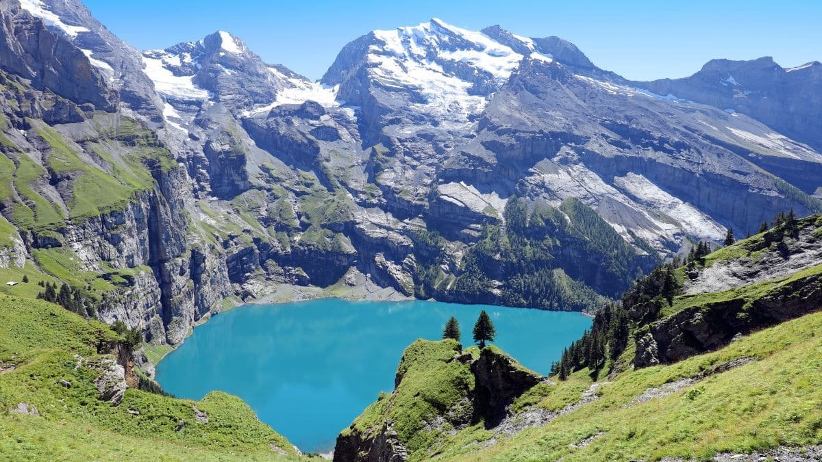 A breathtaking hike leading to the turquoise Oeschinen Lake, surrounded by towering Swiss Alps.