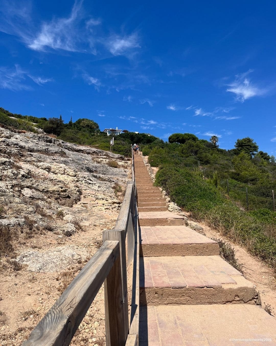 Stone stairs carved into the cliffs along the trail, offering a glimpse of the terrain hikers will encounter.