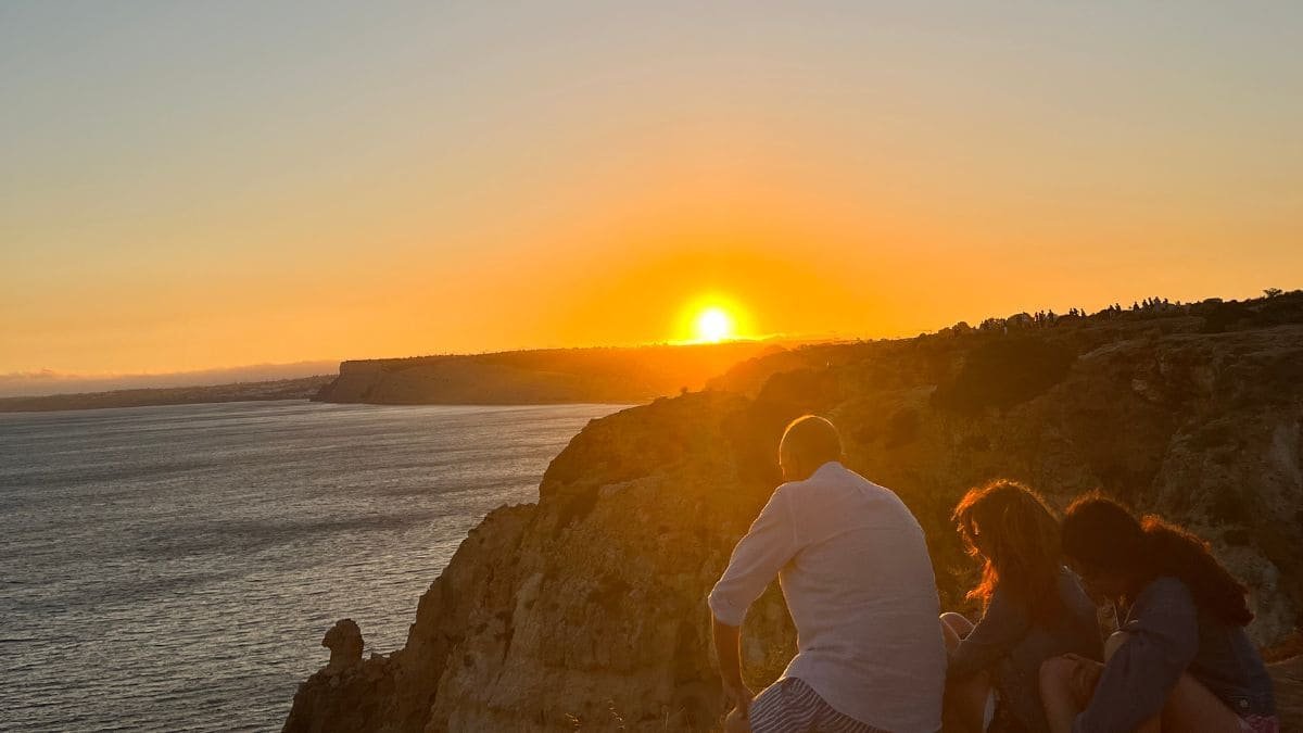 Ponta da Piedade Sunset – A dramatic cliffside view with the golden sun setting over the Atlantic Ocean.