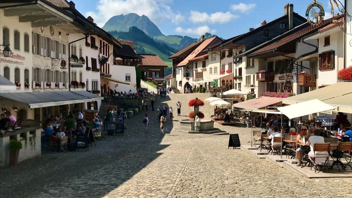 The medieval hilltop village of Gruyères, featuring the iconic Gruyères Castle and cheese factory – a tasty day trip from Geneva.