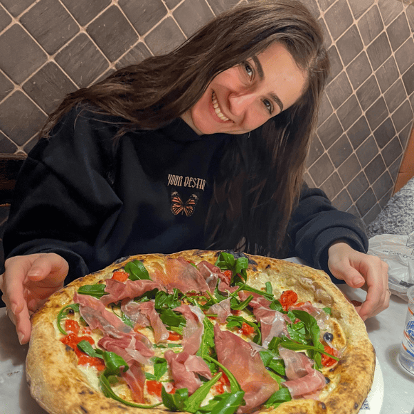 The happy face of Rumi right before eating our first pizza in Naples