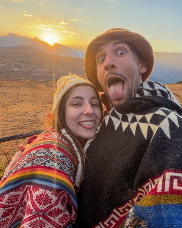 Ru & Tiago in Andean ponchos at sunset at Sky Dome Peru, Sacred Valley
