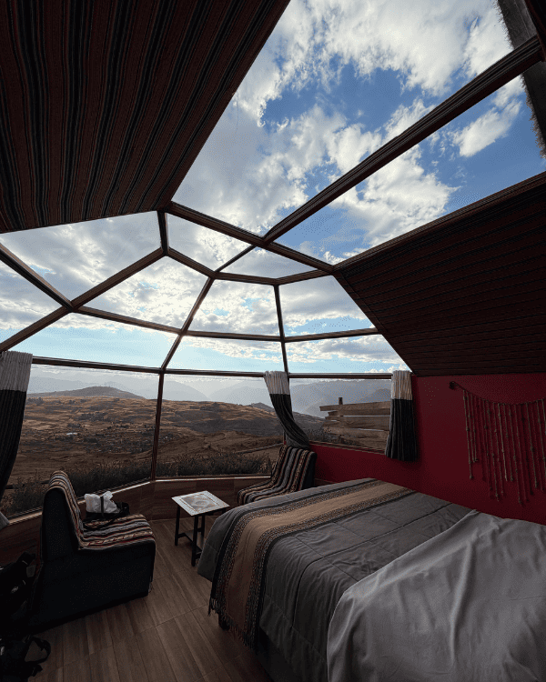Inside our glass dome at Sky Dome Peru, with the bed under the panoramic roof