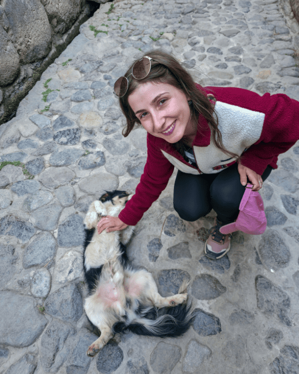 Playing with a cute dog in the streets of Ollantaytambo, Peru